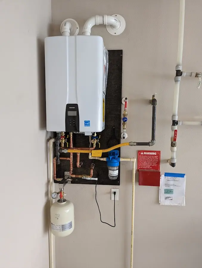 Professional plumber installing copper piping in a Mechanicsville home